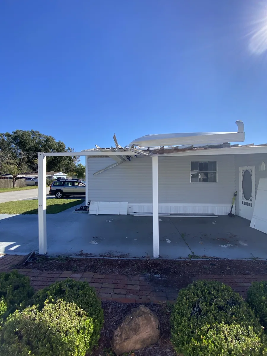 Damaged mobile home carport before work